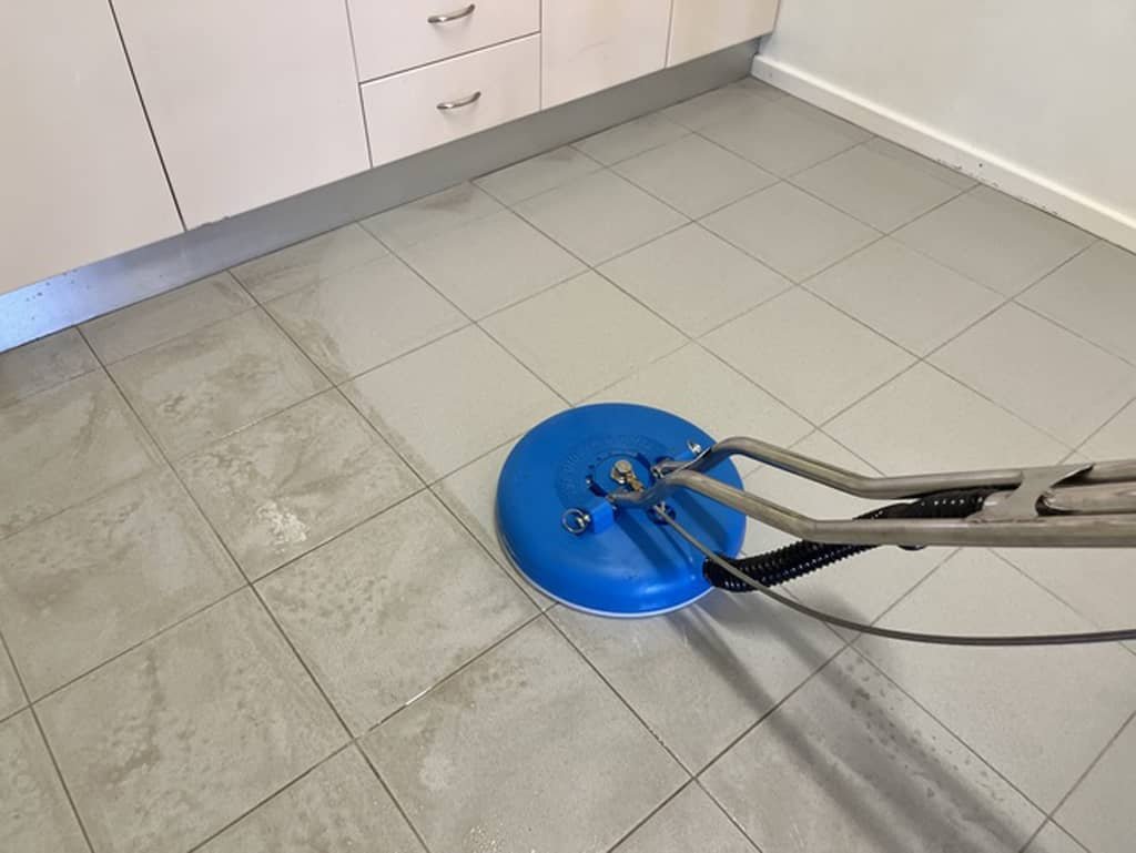 Professional tile and grout cleaning Geelong technician restoring a dirty kitchen floor